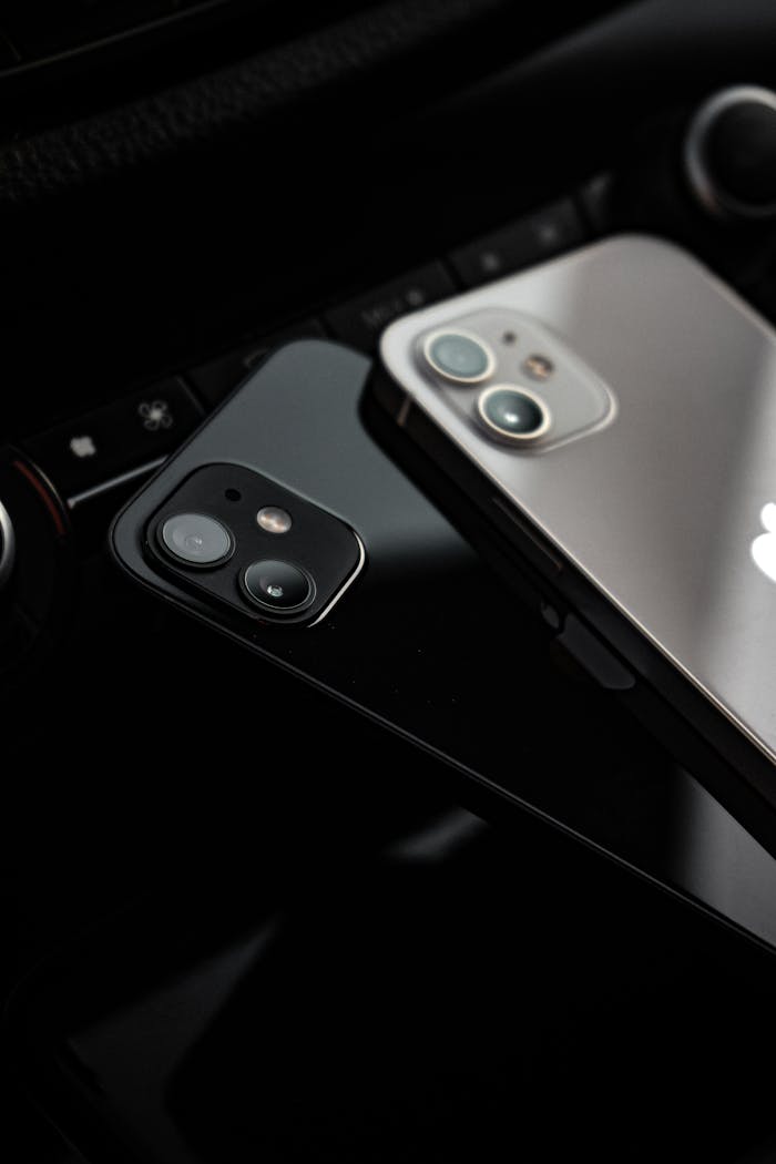 pexels-photo-9555106 Detailed focus on two smartphones with reflection, showcasing modern design and tech trends.